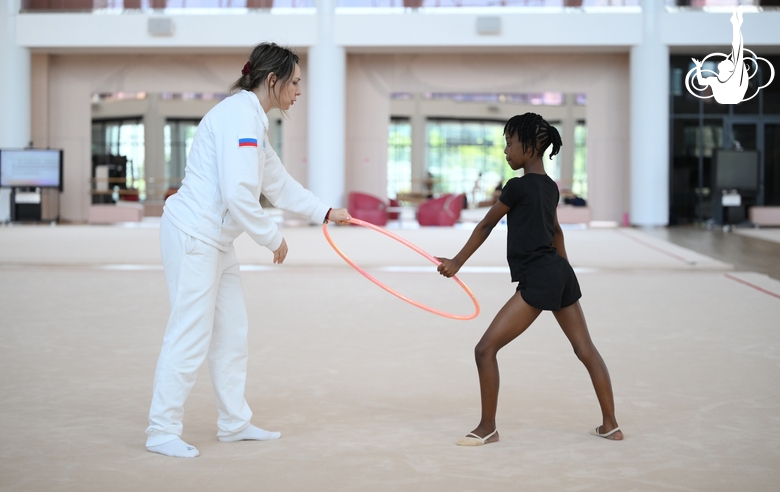 Academy coach Olesya Kovaleva with gymnast Nkenko Sita Davina Chanselvi during the hoop exercise