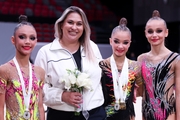 Coach Evgenia Eliseeva and gymnasts Elina Khabirova, Ksenia Savinova and Yana Zaikina after the award ceremony