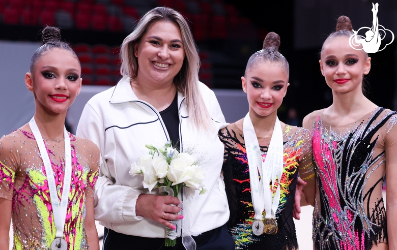 Coach Evgenia Eliseeva and gymnasts Elina Khabirova, Ksenia Savinova and Yana Zaikina after the award ceremony