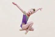 Young gymnast in a jump during a performance at the All-Russian Formula of Victory