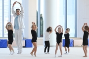 Academy coach Olesya Kovaleva with young gymnasts during training