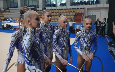 Olympic champion Alina Kabaeva helps the Academy group gymnasts refine the details of their five-hoop routine