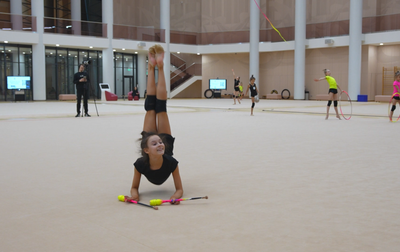 Olympic champion Alina Kabaeva helps Polina Semenova practice her clubs routine