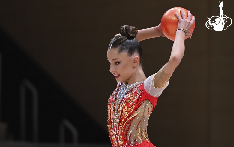 Gymnast does an exercise with a ball during an individual program performance