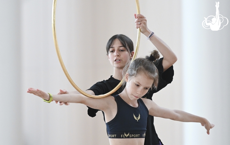 Coach Elizaveta Chernova with a gymnast during class