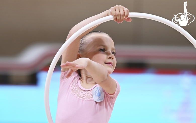 Young gymnast during an exercise with a hoop at the mAlinka tournament