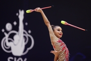 Gymnast during an exercise with clubs