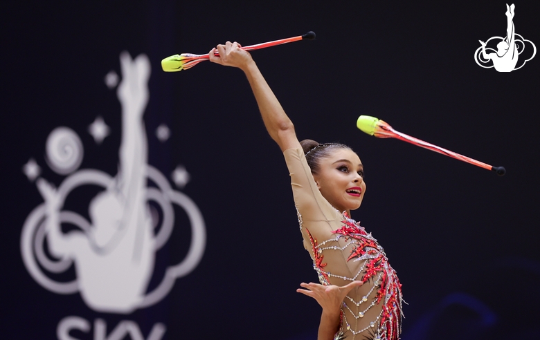 Gymnast during an exercise with clubs