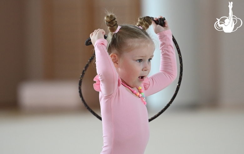 Young gymnast during an exercise with a jump rope