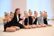 Teacher Anna Pukhova with young gymnasts during a rhythmics class