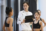 Gymnasts from China during the training session with the coach