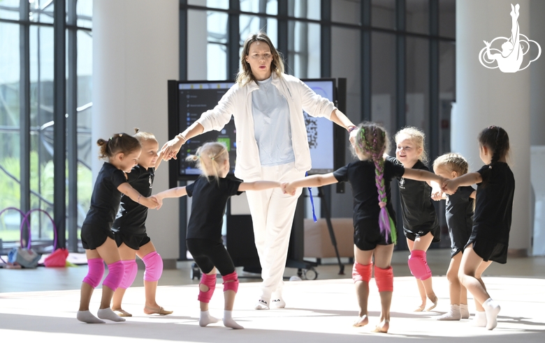 Academy coach Olesya Kovaleva with young gymnasts