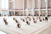 Gymnasts and coach Alina Protasova during practice at the training camp in the Academy