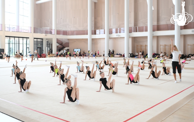 Gymnasts and coach Alina Protasova during practice at the training camp in the Academy