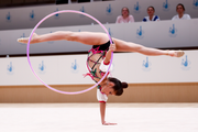 Karolina Tarasova performs an element with a hoop during an assessment training session