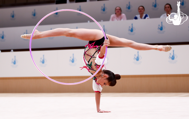 Karolina Tarasova performs an element with a hoop during an assessment training session