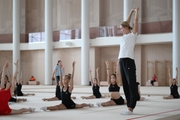 Coach Alina Protasova with gymnasts during practice at the training camp in the Academy