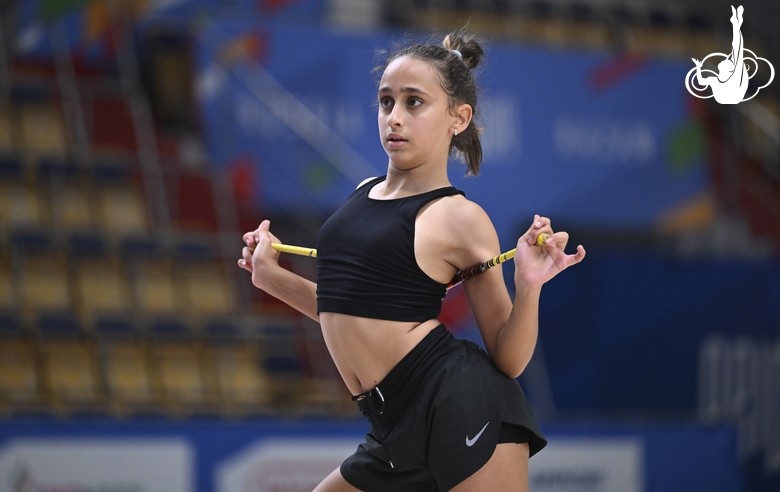 Gymnast during an exercise with clubs during mat testing before the BRICS Games