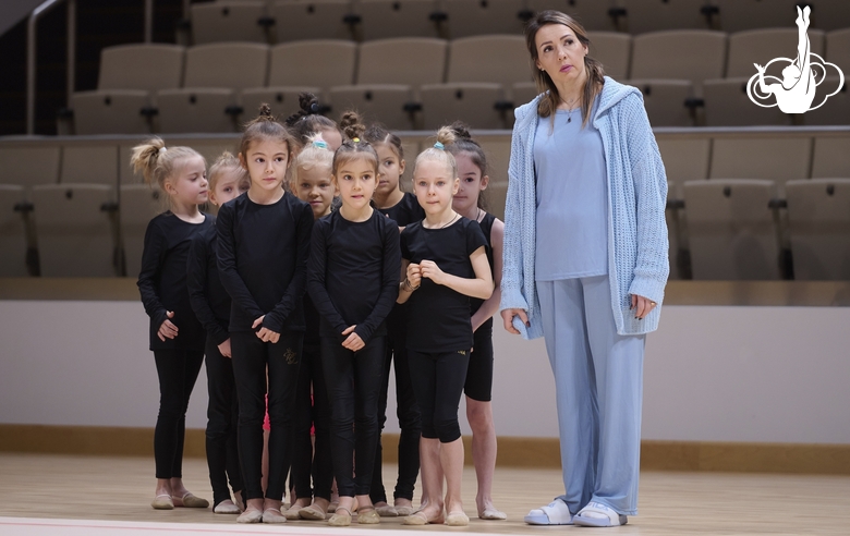 Academy coach Olesya Kovaleva with young gymnasts during training