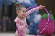 Young gymnast during an exercise with a hoop at the mAlinka tournament