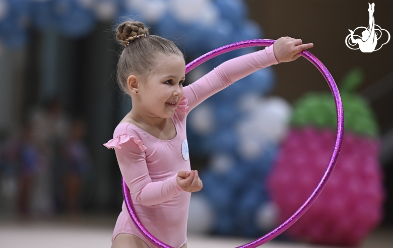 Young gymnast during an exercise with a hoop at the mAlinka tournament