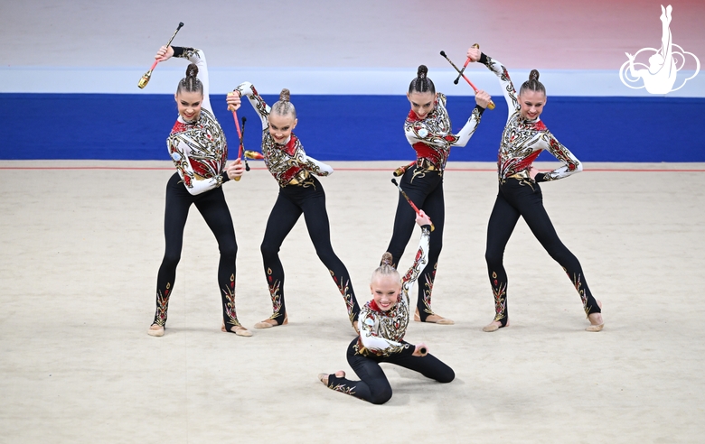 Academy group exercise gymnasts during the exercise with clubs