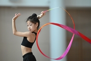 Chinese gymnast  performs an exercise with a ribbon