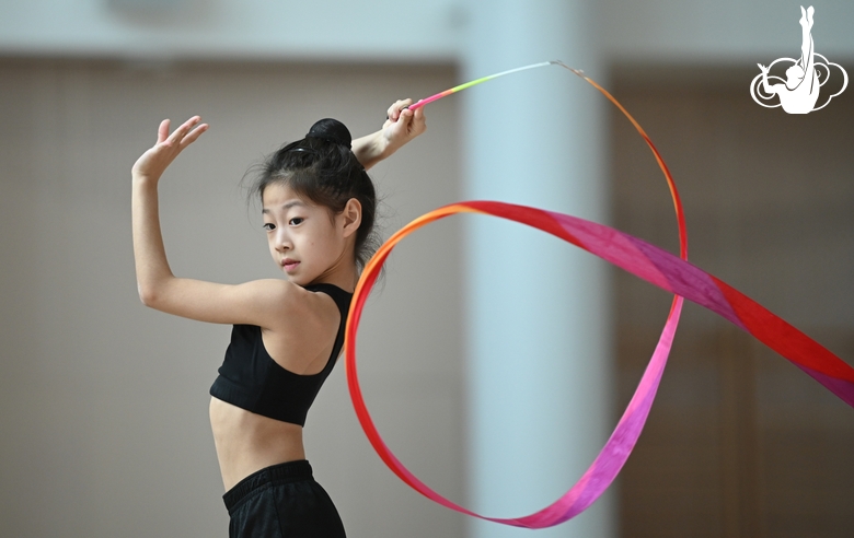 Chinese gymnast  performs an exercise with a ribbon