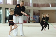 Academy Coach Anna Ustsova with young gymnasts during the exercise