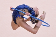 Ksenia Savinova amidst a jump in an exercise with a hoop at an assessment training session