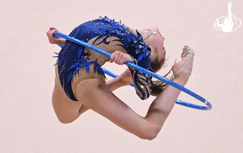 Ksenia Savinova amidst a jump in an exercise with a hoop at an assessment training session