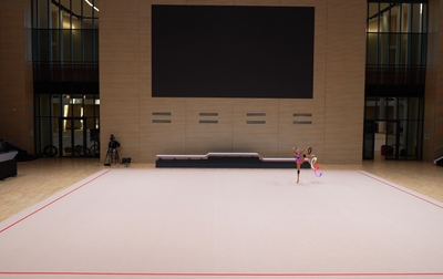 Olympic champion Alina Kabaeva helps Eva Kononova make her ribbon routine more impressive