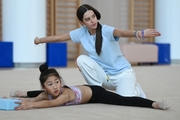 Academy Coach Elizaveta Chernova and gymnasts from China during the training session