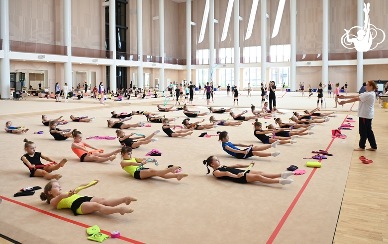 Gymnasts with a coach during class