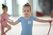 Young gymnast during an exercise with a jump rope