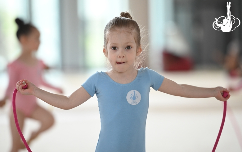 Young gymnast during an exercise with a jump rope