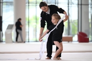 Academy coach Olga Frolova and a young gymnast during a ribbon routine