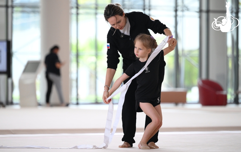 Academy coach Olga Frolova and a young gymnast during a ribbon routine