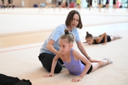 Coach Olga Minigalina with gymnasts during practice at the training camp in the Academy
