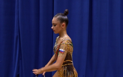 Alina Kabayeva helps Ksenia Savinova prepare for the all-around performance at the Crystal Rose