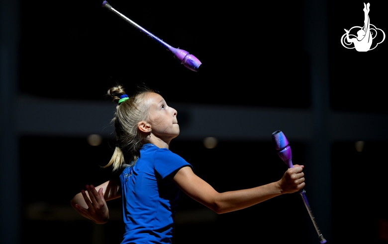 Gymnast during an exercise with clubs