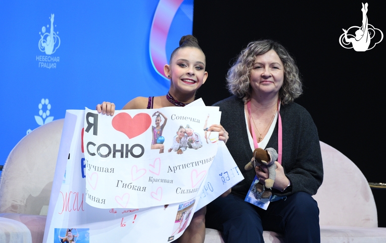 Sofia Ilteryakova with coach Natalia Glemba after an exercise with a ball