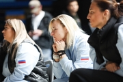 Coaches watch Academy students warm up before the start of the tournament