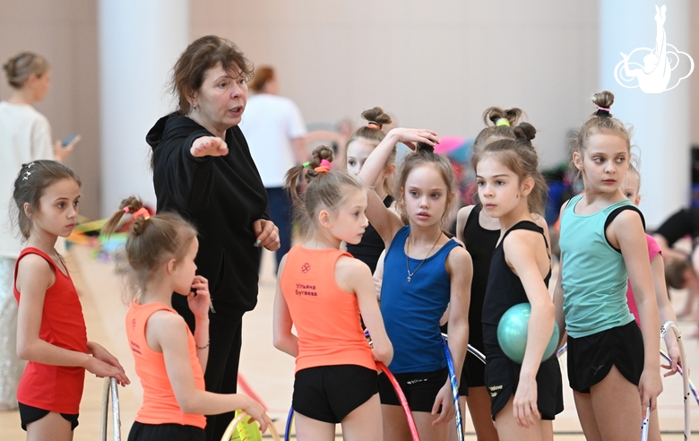 Gymnasts with a coach during class