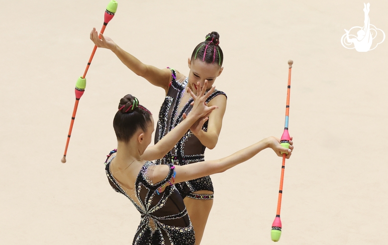 Gymnasts during an exercise with clubs