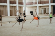 Young gymnasts work on lateral balance during training