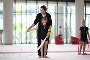 Academy coach Olga Frolova and a young gymnast during a ribbon routine