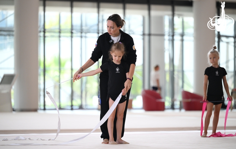 Academy coach Olga Frolova and a young gymnast during a ribbon routine