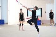 Dina Averina shows Karolina Tarasova how to work with clubs