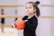 Young gymnast during the ball exercise